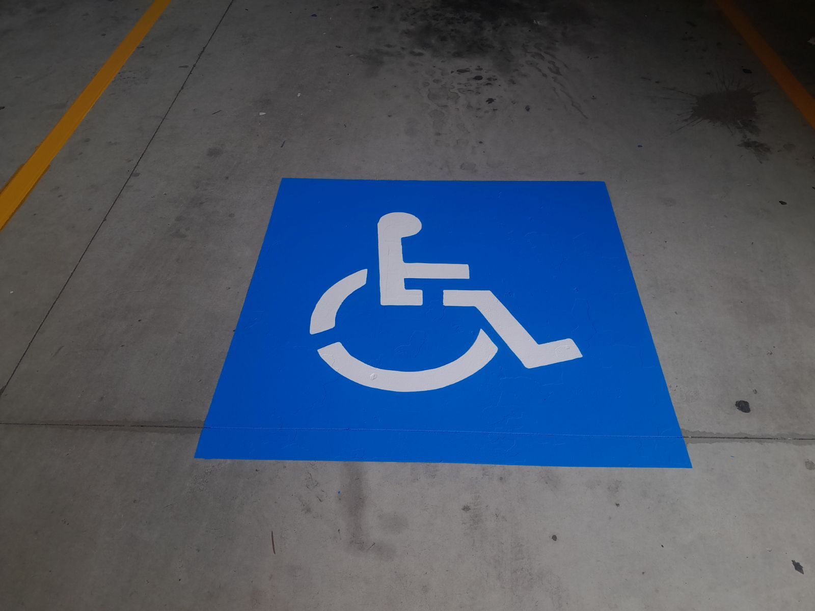 A Blue Sign With A White Wheelchair Symbol On It — Wide Bay Line Marking in Wondunna, QLD