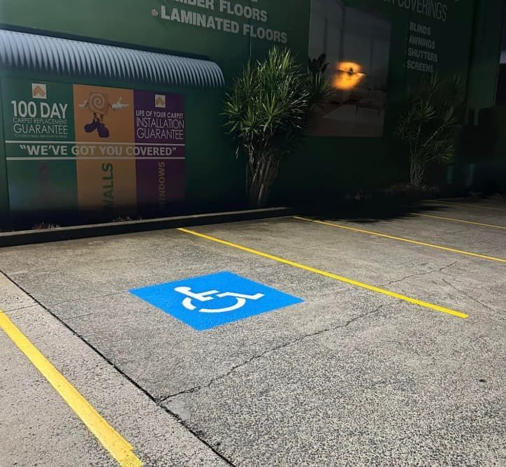 A Handicap Sign Is Painted On The Side Of A Parking Lot — Wide Bay Line Marking in Wondunna, QLD