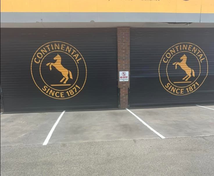 Two Continental Logos Are Painted On The Side Of A Building — Wide Bay Line Marking in Wondunna, QLD