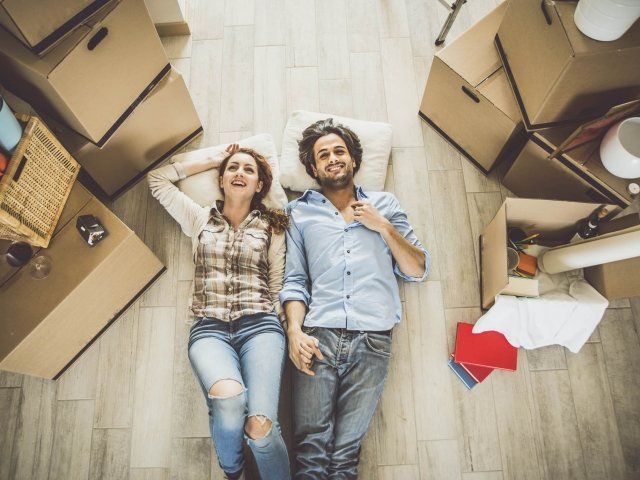 Young couple moving in into new apartment