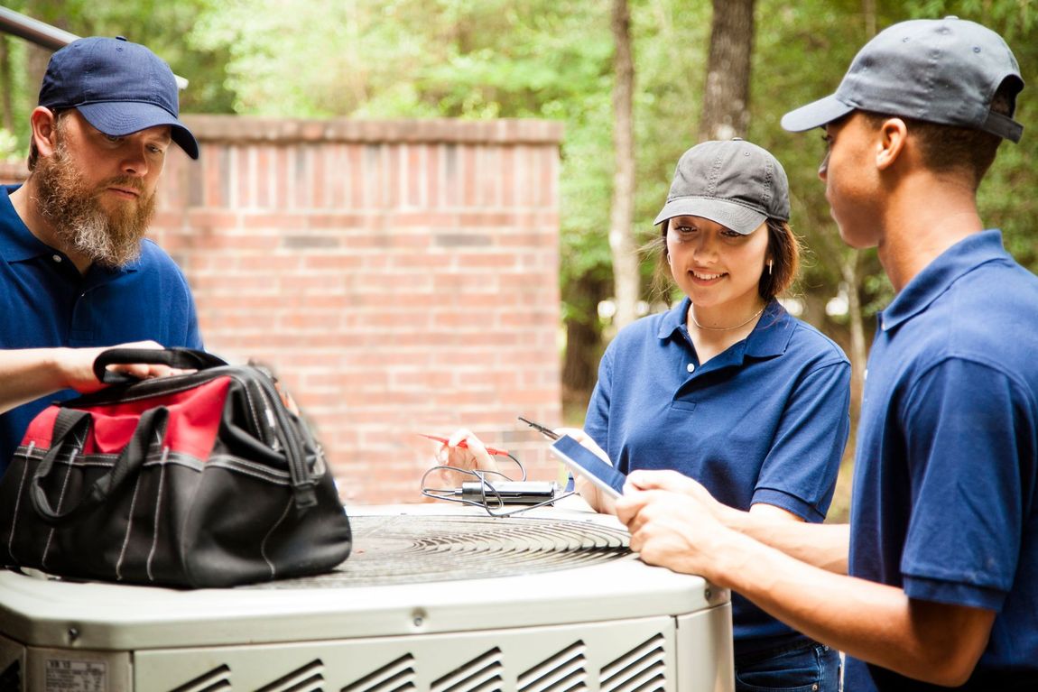 Three technicians inspecting an appliences