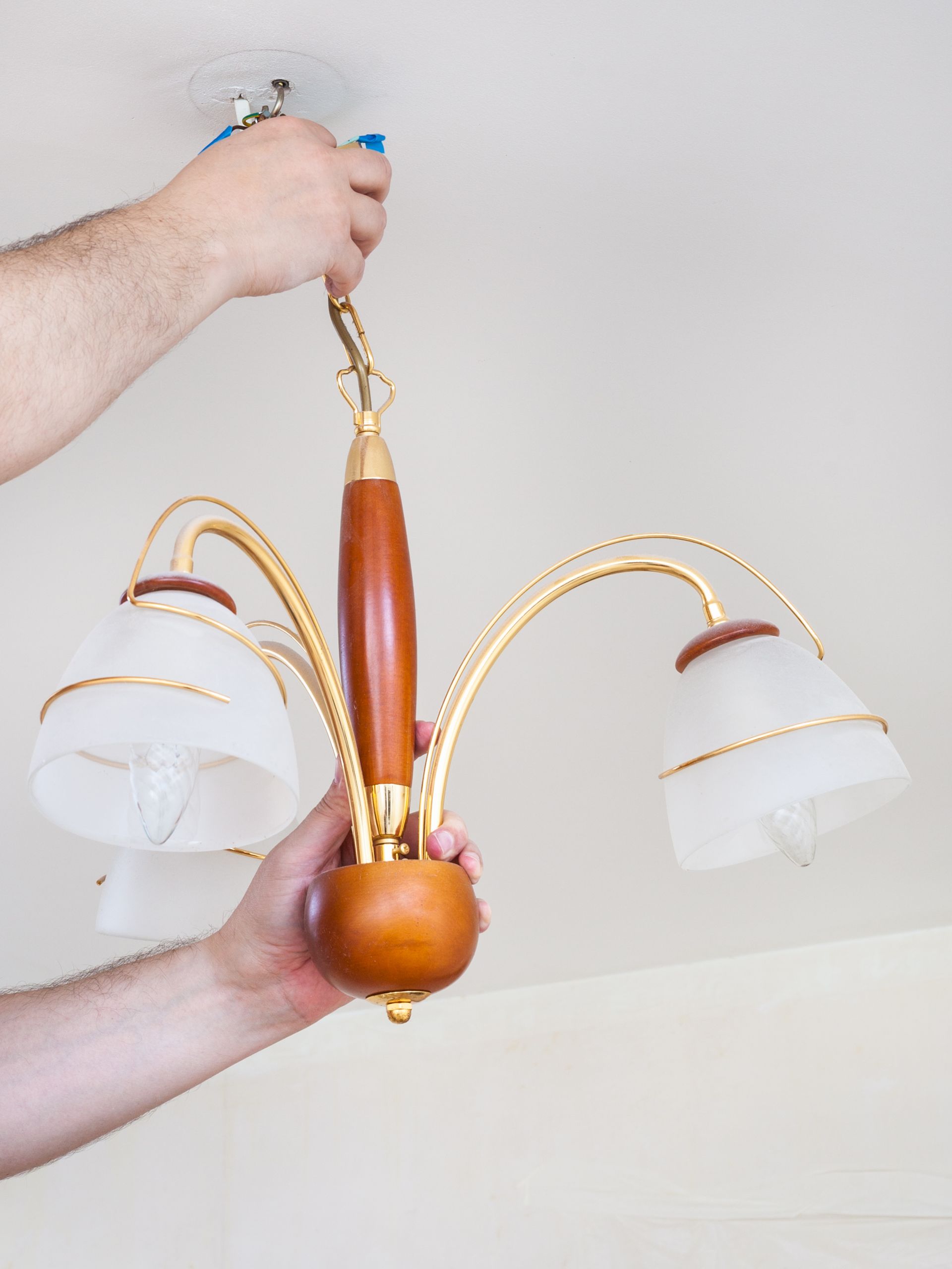 Person Installing a Chandelier
