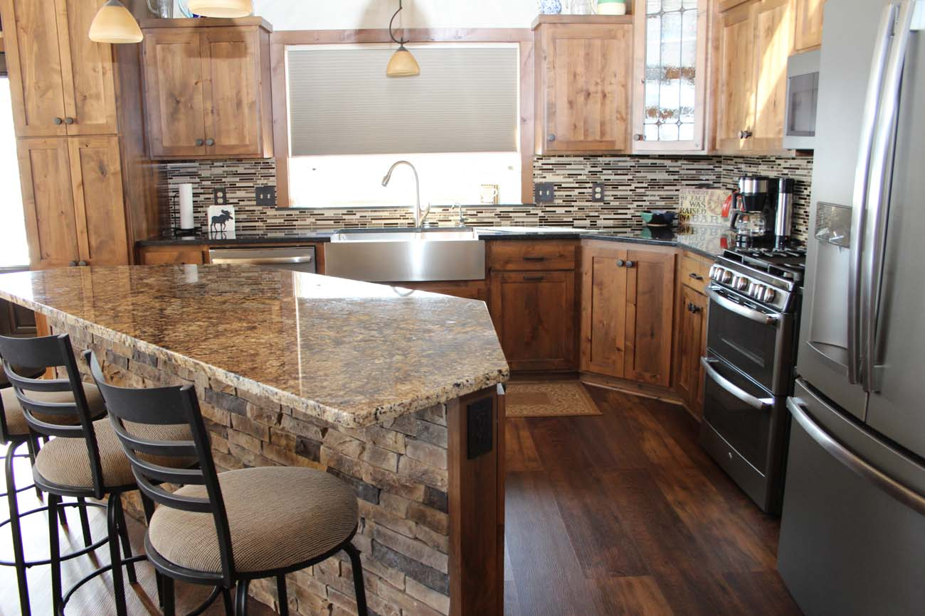 A kitchen with granite counter tops and stainless steel appliances