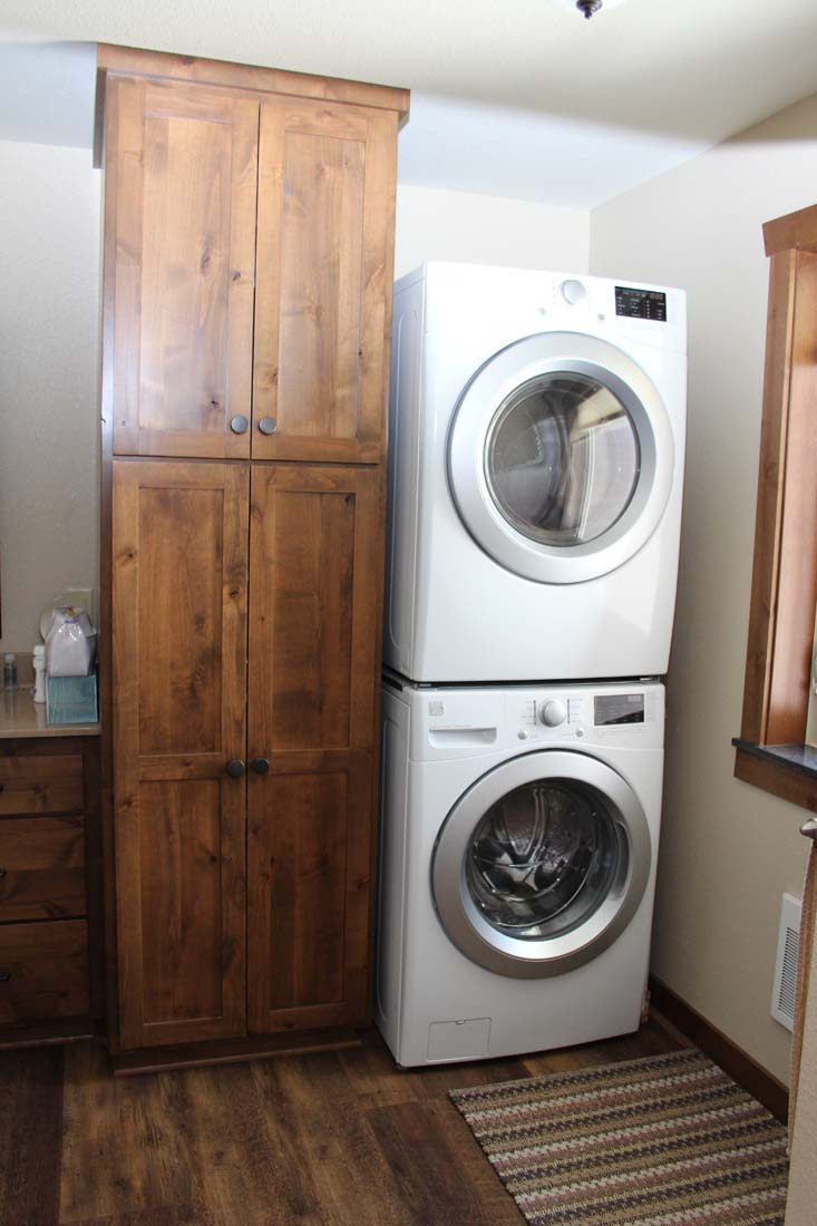 A washer and dryer are stacked on top of each other in a laundry room.