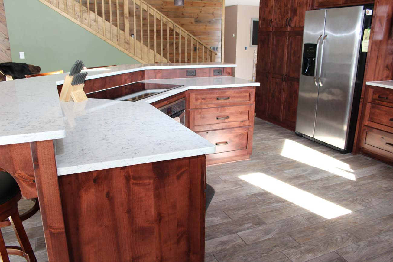 A kitchen with stainless steel appliances and wooden cabinets