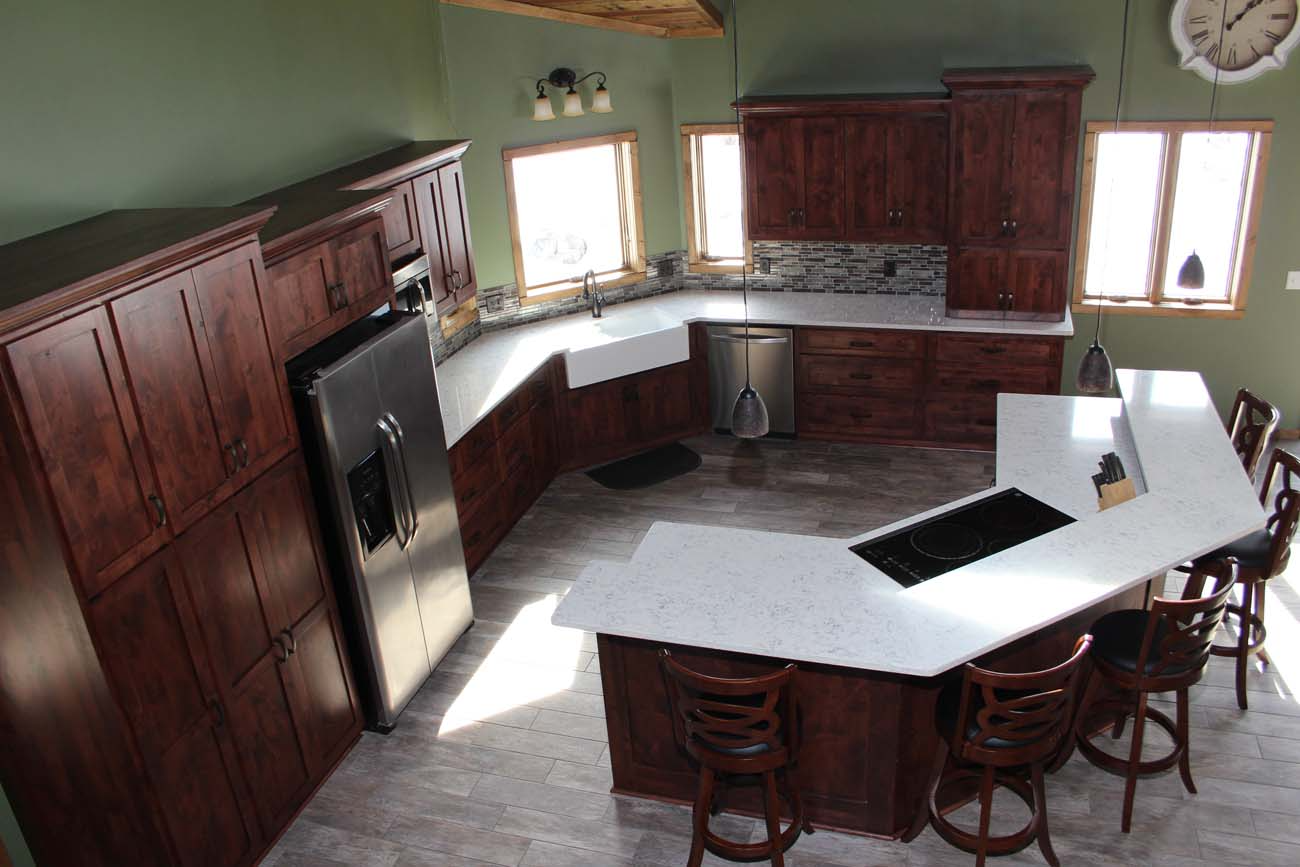A kitchen with a large island and a clock on the wall