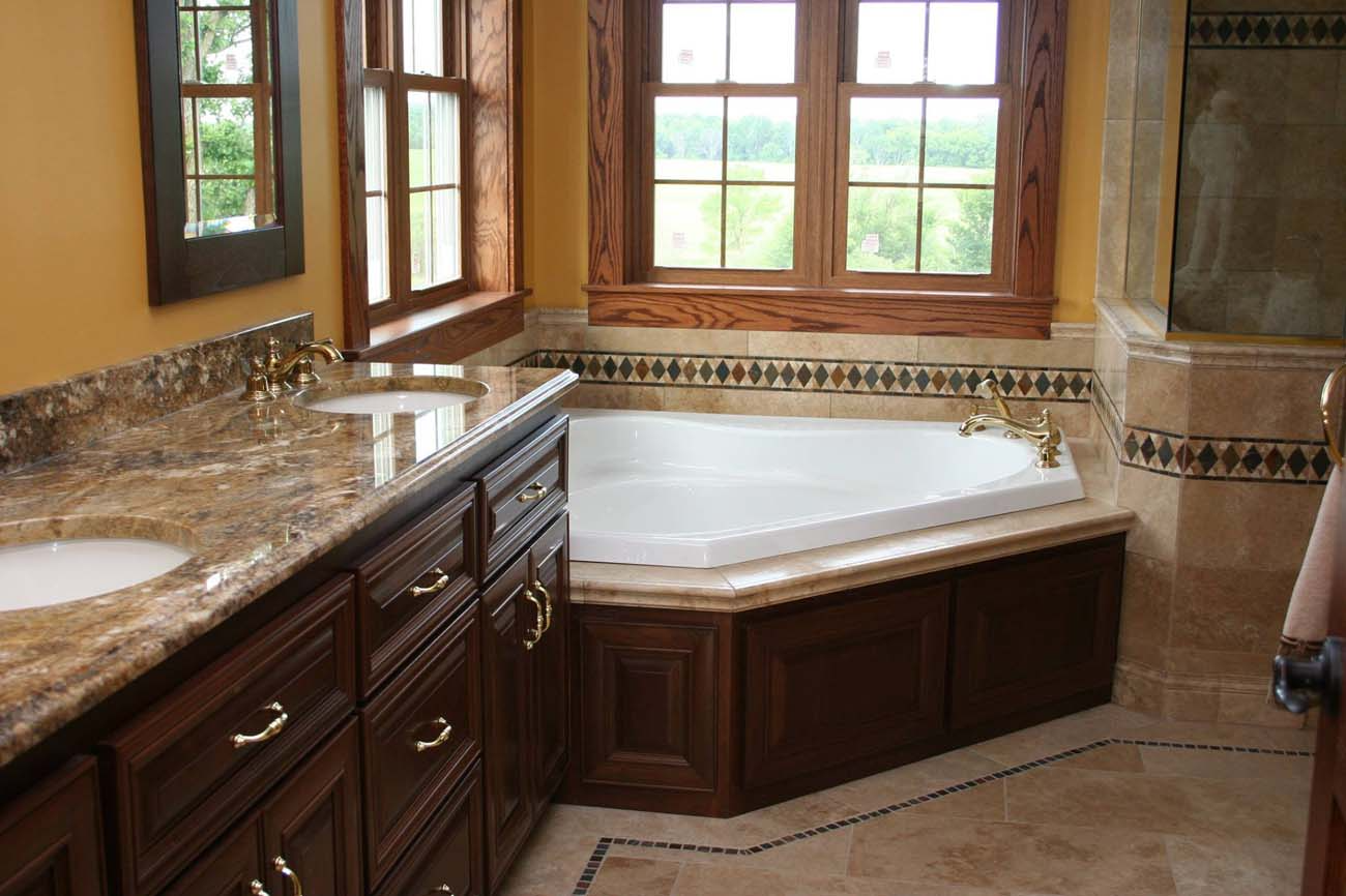 A bathroom with two sinks and a jacuzzi tub