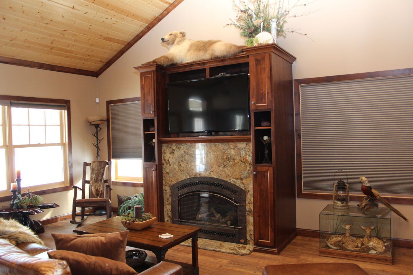 A living room with a fireplace and a flat screen tv