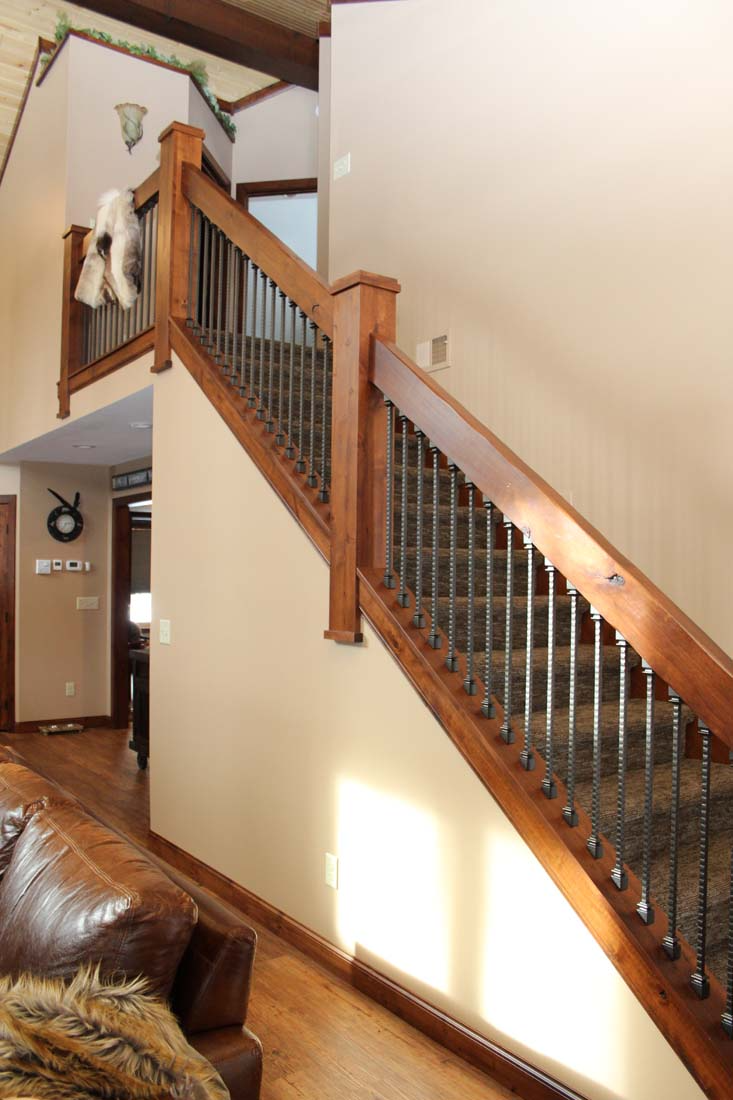 A living room with stairs leading up to the second floor
