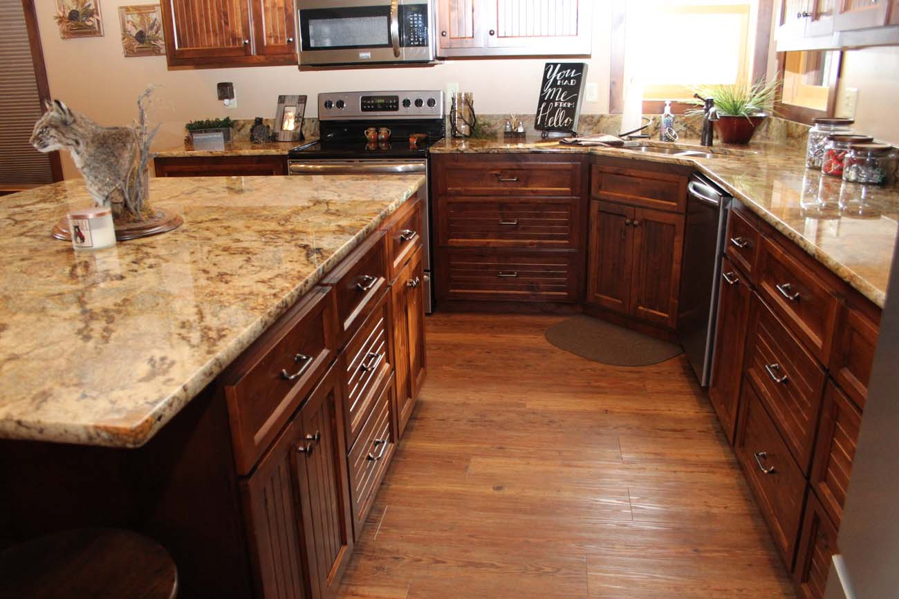 A kitchen with wooden cabinets and granite counter tops