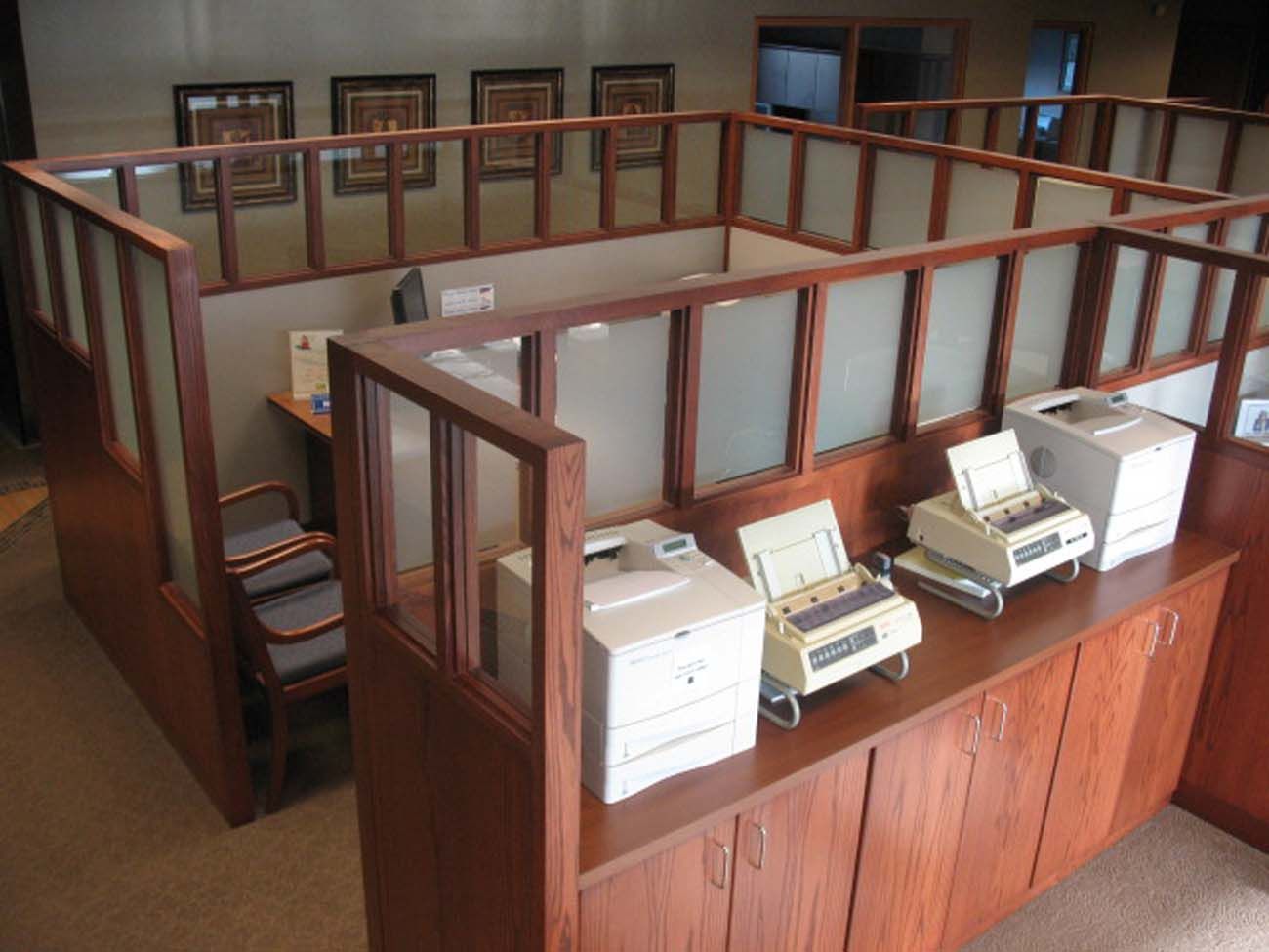 A cubicle with a printer and a fax machine