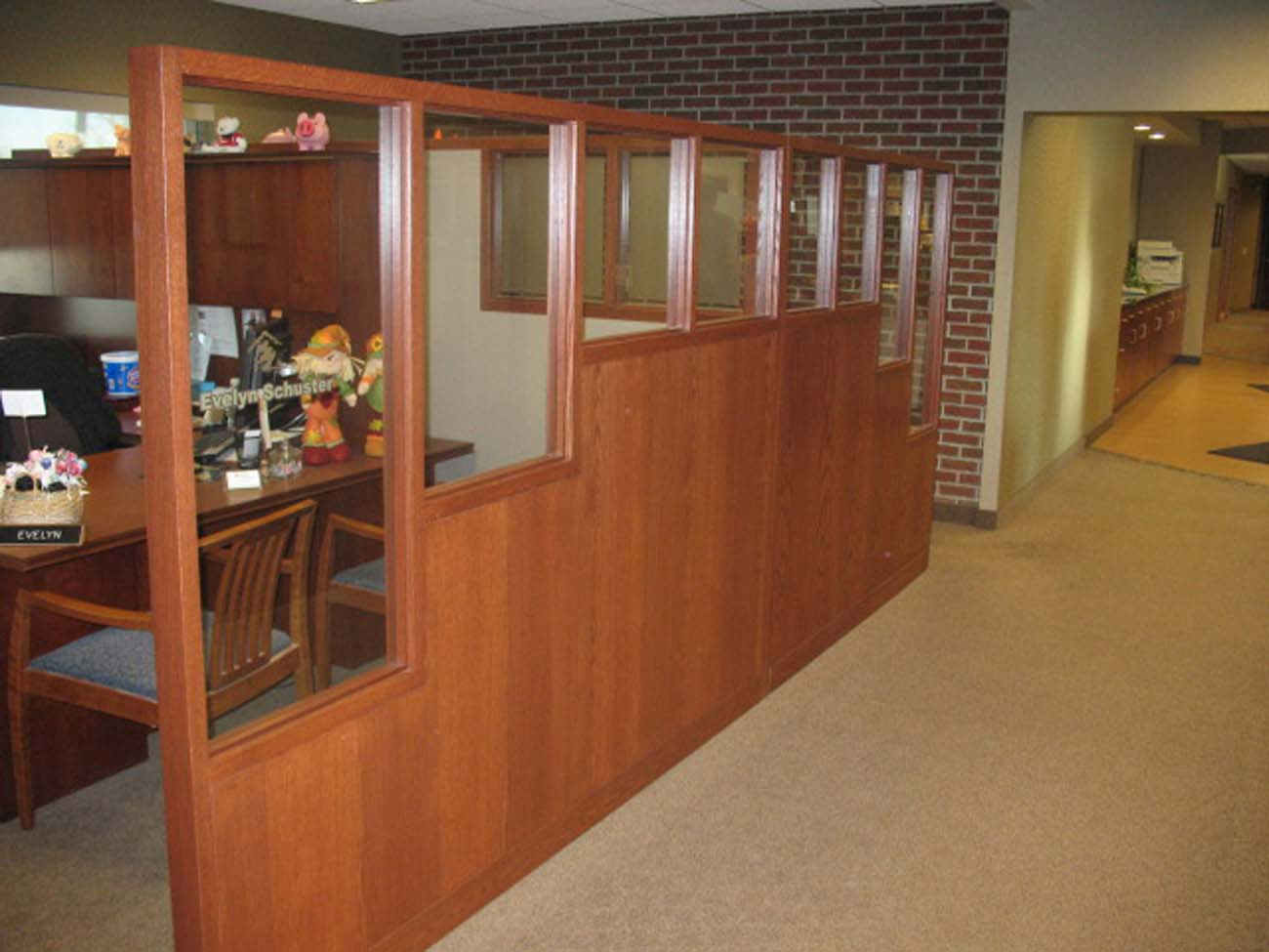 A room with a brick wall and a wooden divider