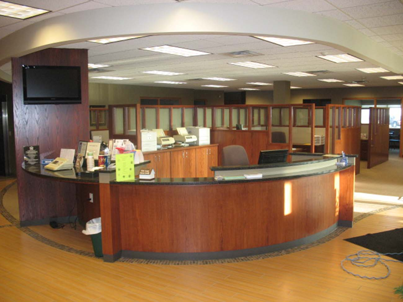 A large office with a round desk and cubicles