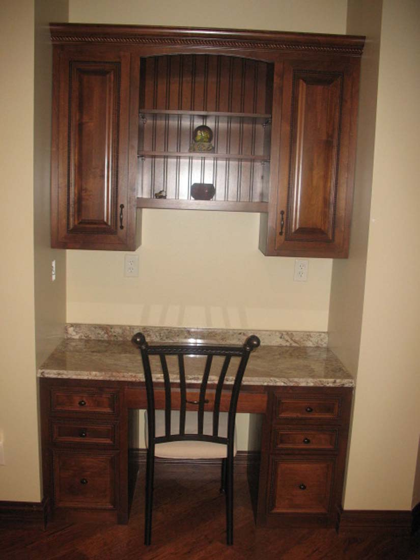 A wooden desk with a chair underneath it