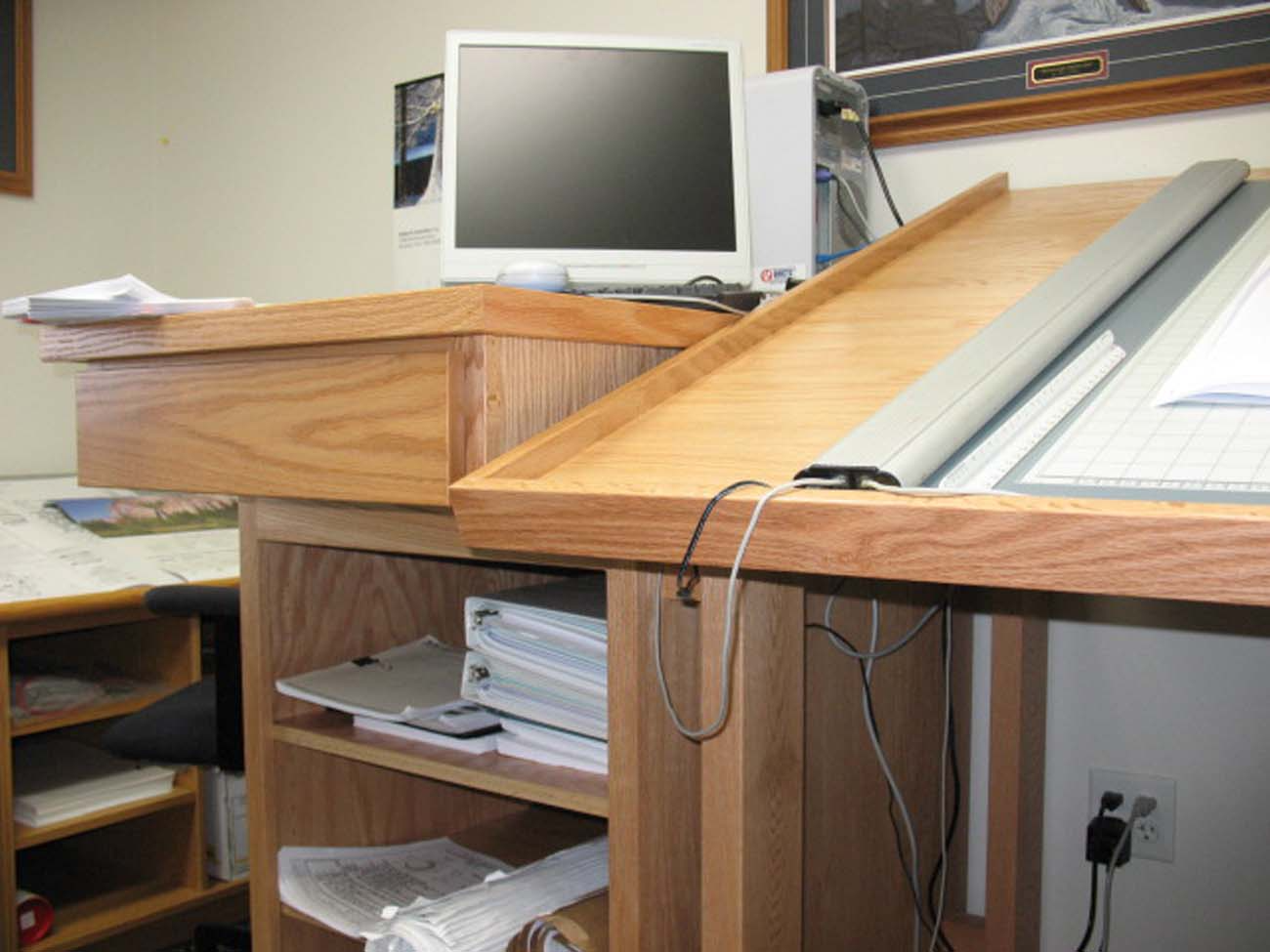 A wooden desk with a computer on top of it