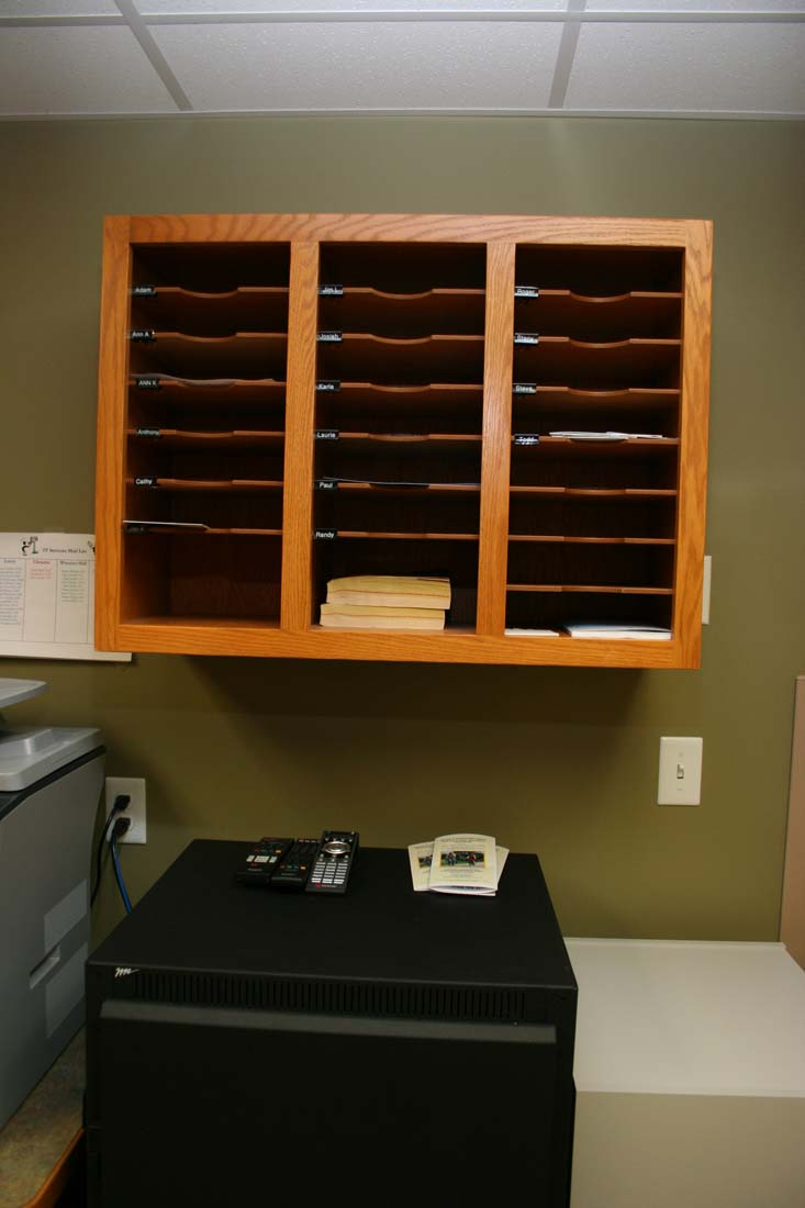 A telephone sits on top of a filing cabinet