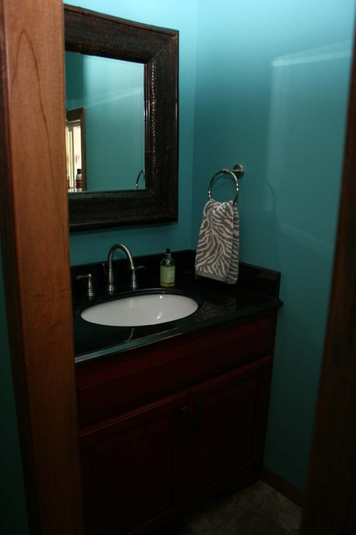 A bathroom with a sink and a mirror on the wall