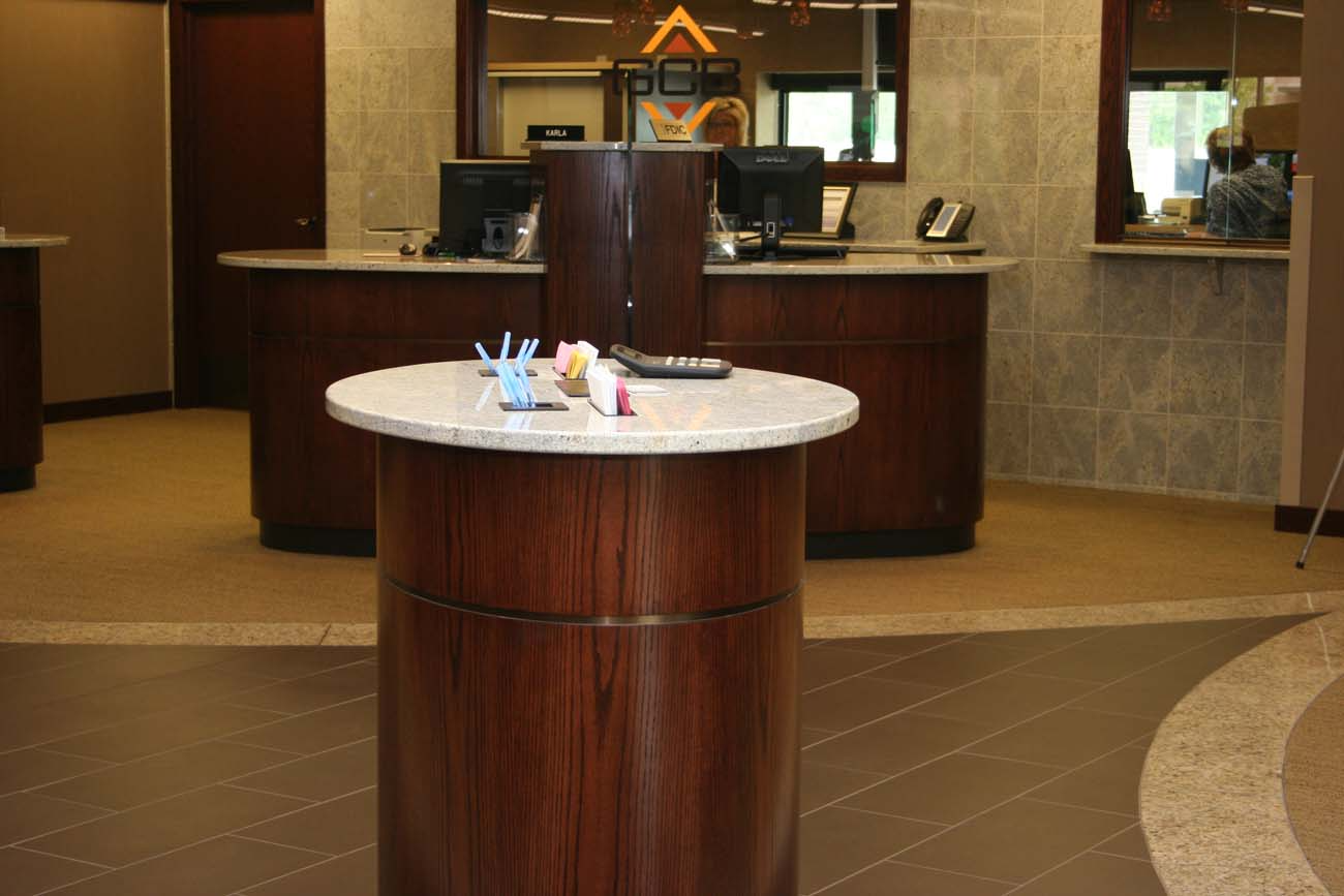 A bank with a round table in front of a counter