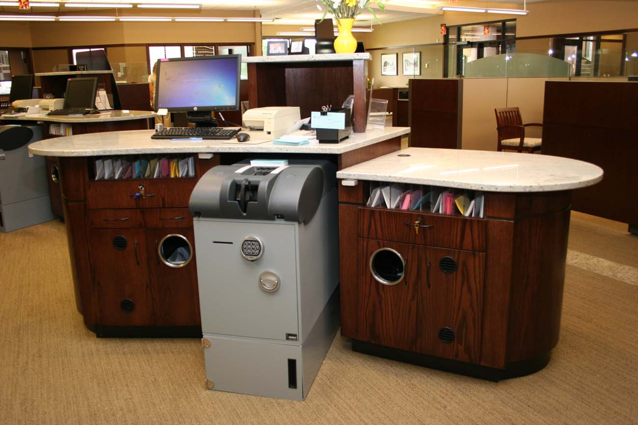 A desk with a computer and a safe on it