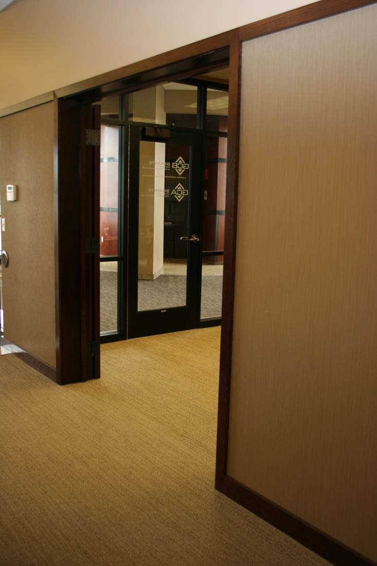 A hallway with a door that is open