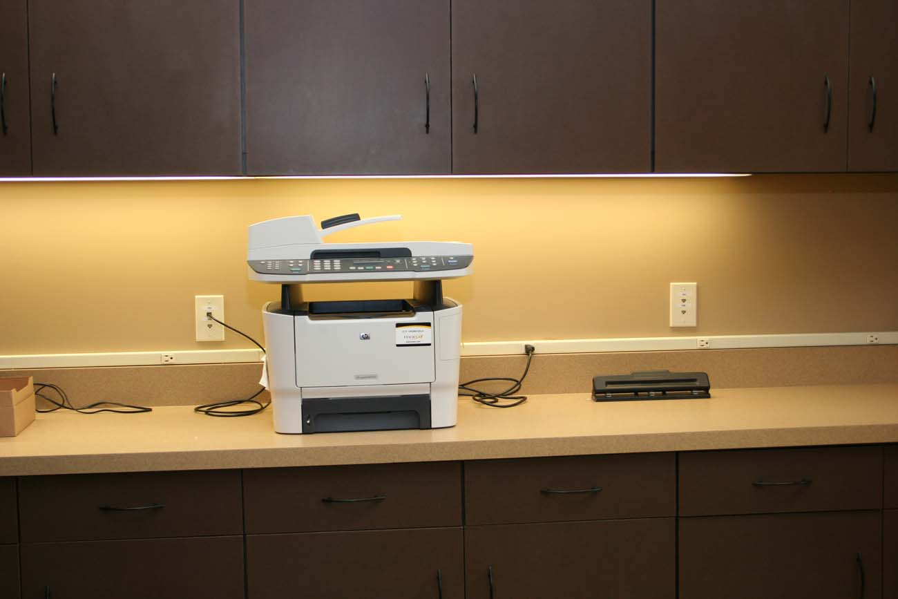 A printer is sitting on a counter in a kitchen