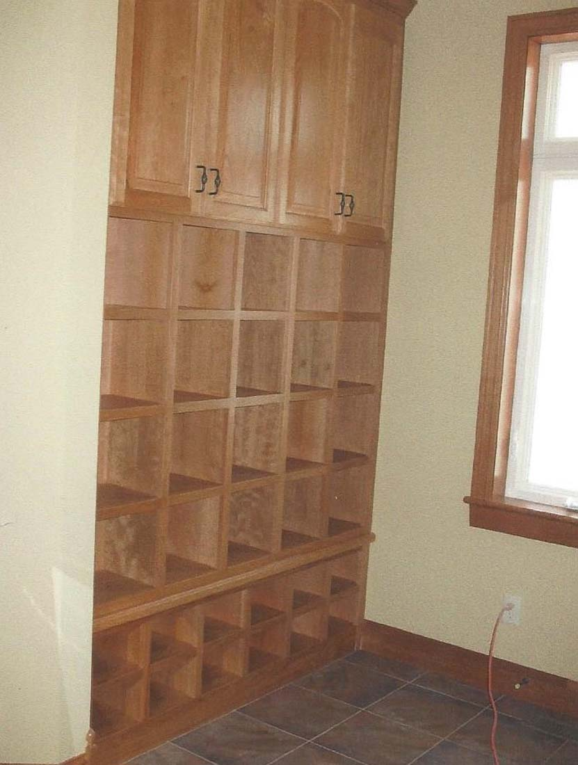 A room with lots of shelves and a window