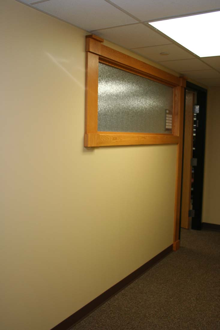 A hallway with a small window on the wall