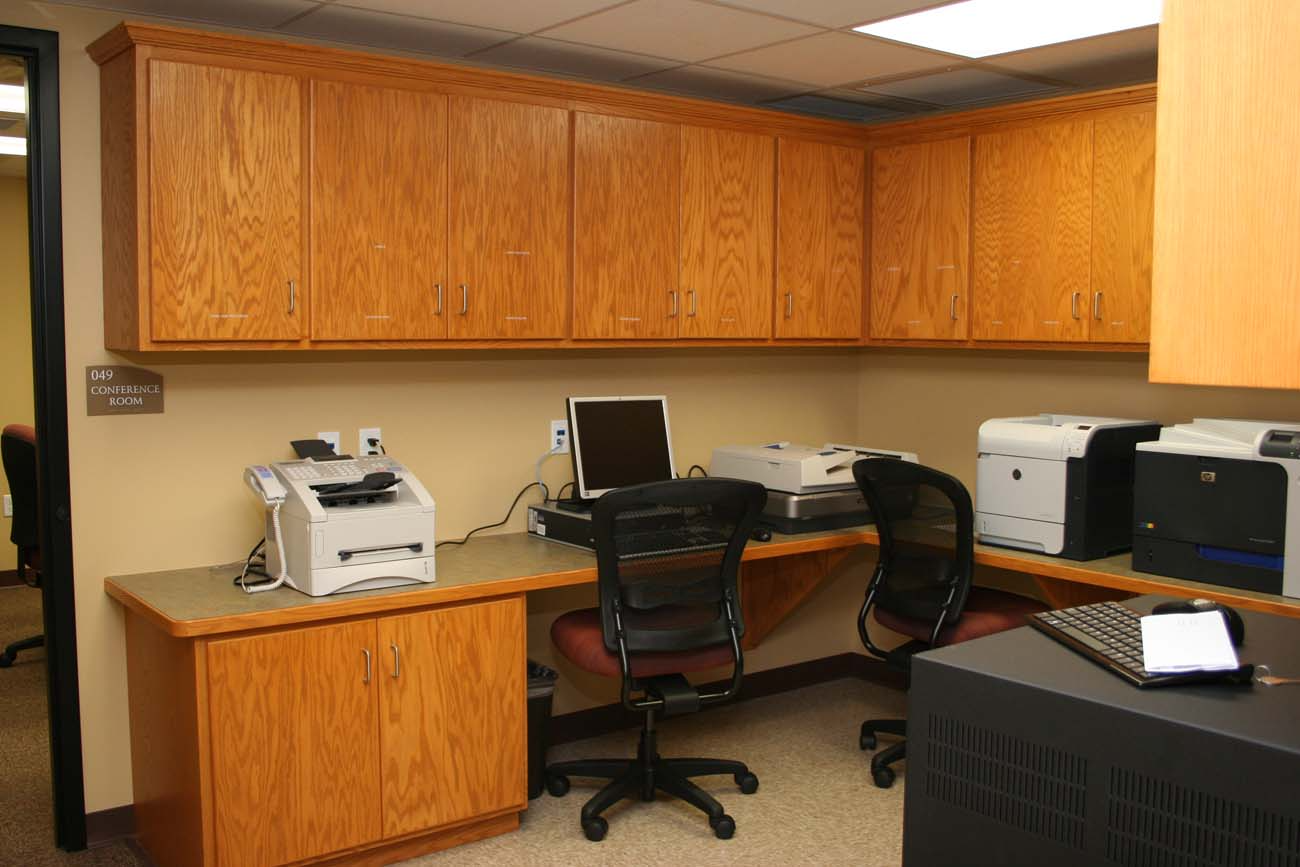 A desk with a computer and a printer on it