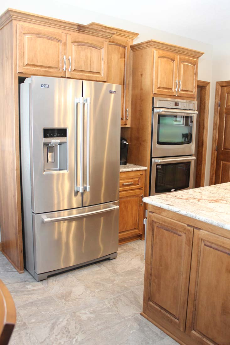 A kitchen with stainless steel appliances and wooden cabinets