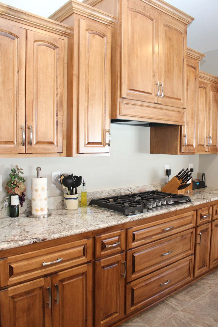 A kitchen with wooden cabinets and granite counter tops
