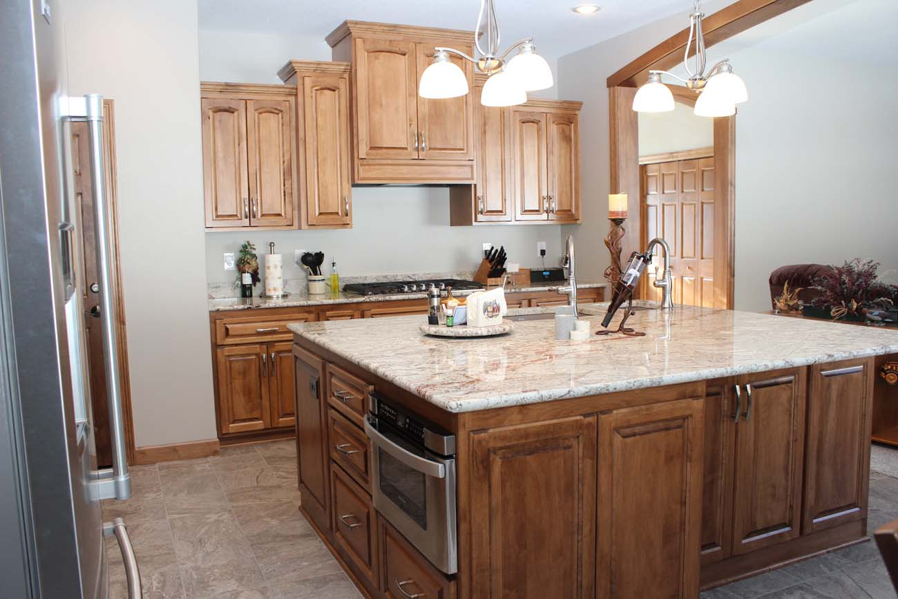 A kitchen with wooden cabinets and granite counter tops