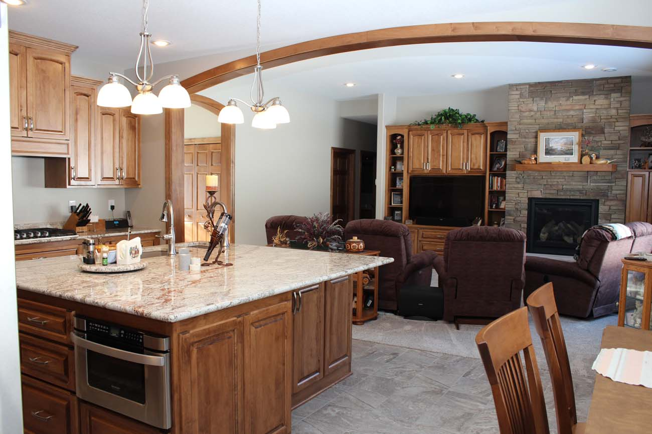 A kitchen with a large island and granite counter tops