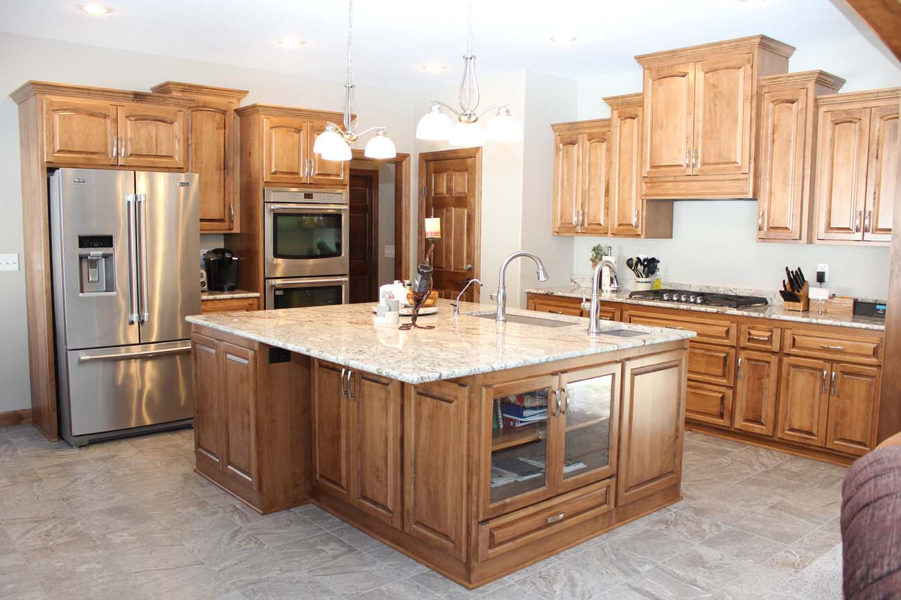 A kitchen with stainless steel appliances and wooden cabinets