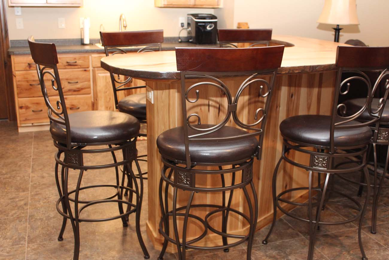 A kitchen with a table and chairs in it