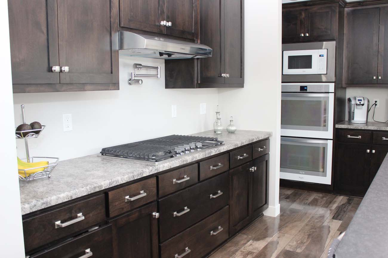 A kitchen with a stove top oven and a microwave.