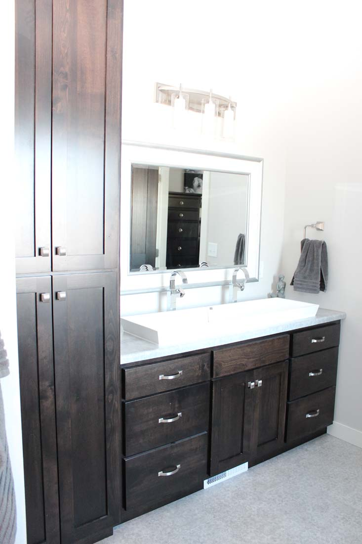 A bathroom with two sinks and a large mirror.