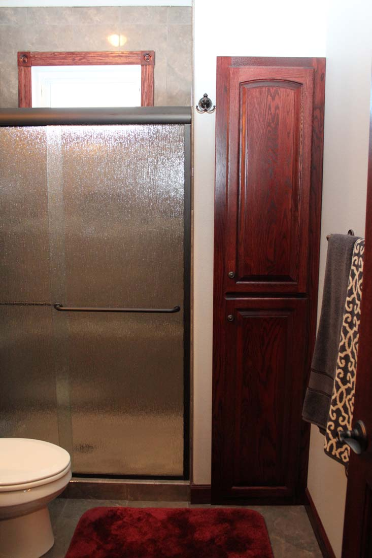 A bathroom with a toilet and a glass shower door