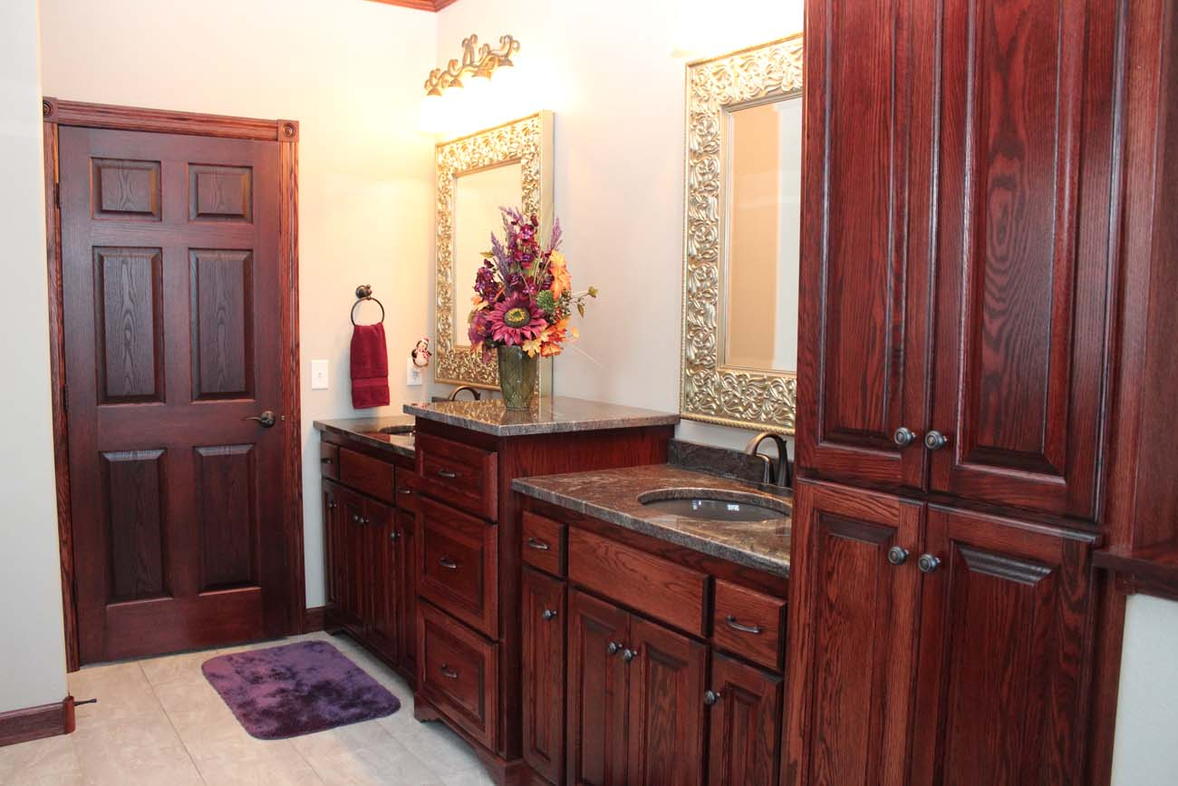 A bathroom with wooden cabinets and a sink