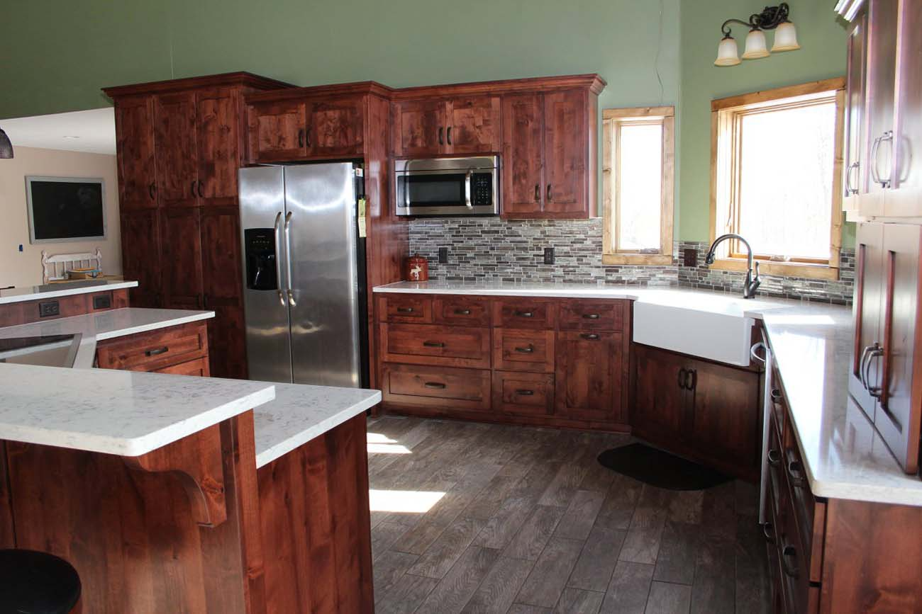 A kitchen with stainless steel appliances and wooden cabinets