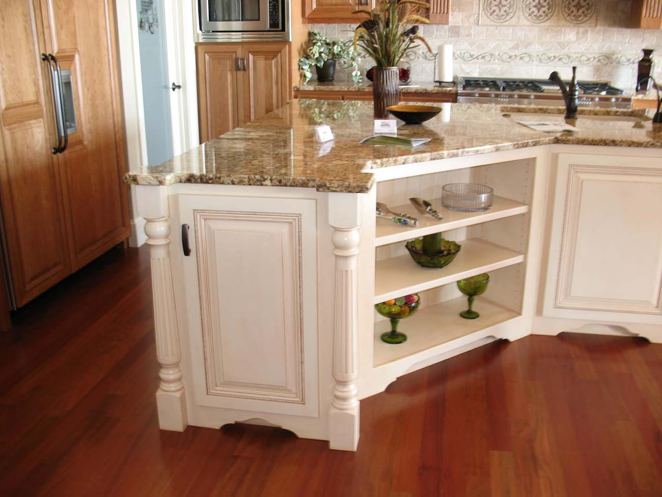 A kitchen with white cabinets and a granite counter top