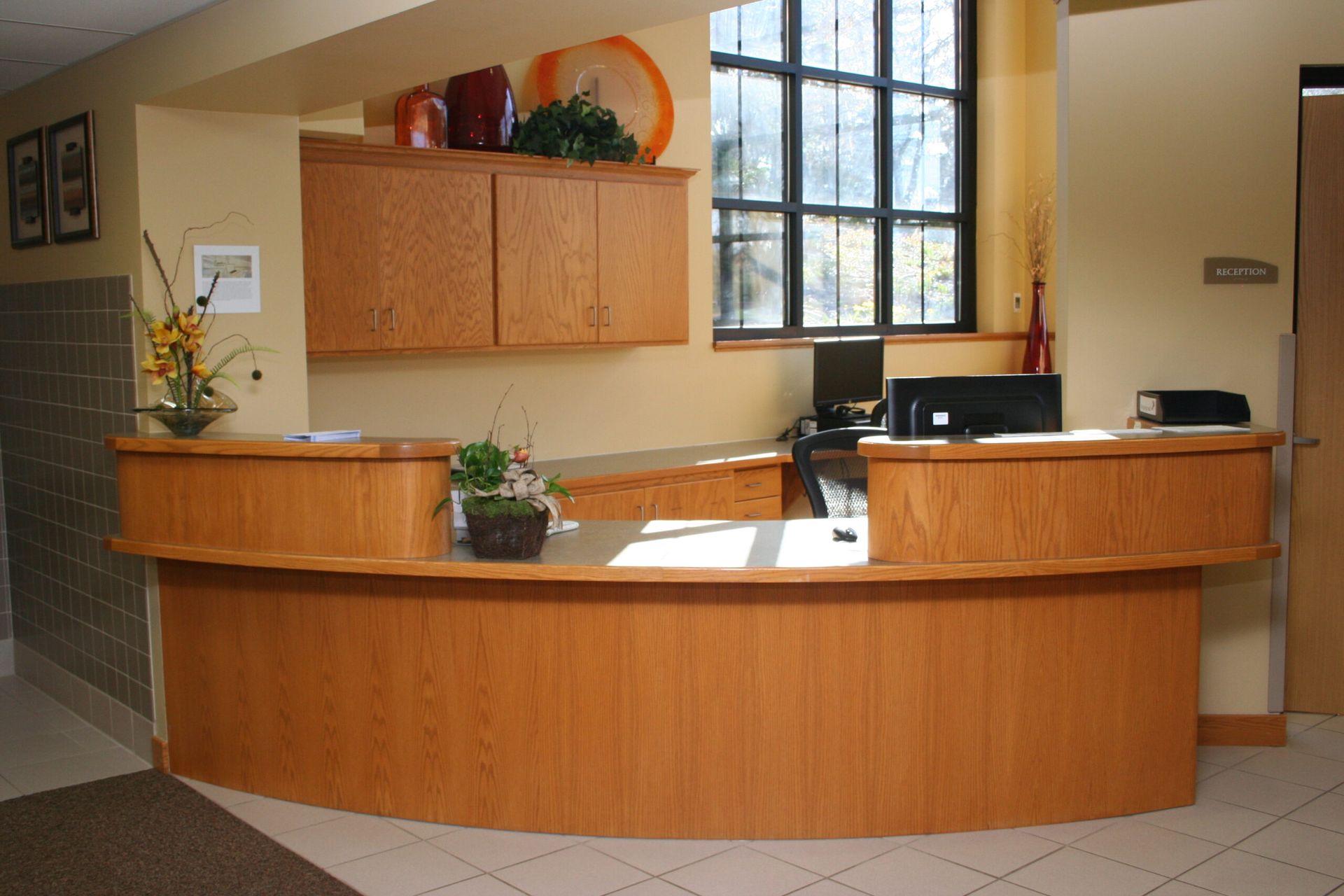 A wooden reception desk with a computer on it