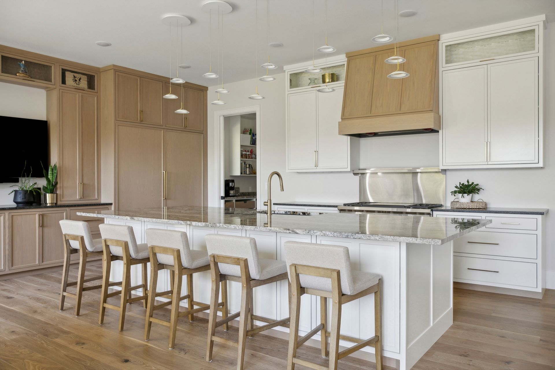 A large kitchen with a large island and stools.