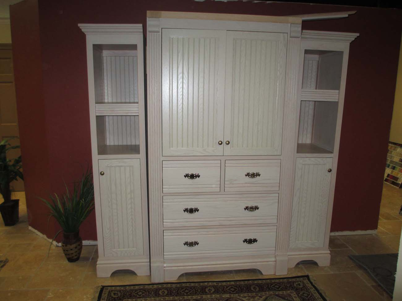 A large white cabinet with lots of drawers and shelves
