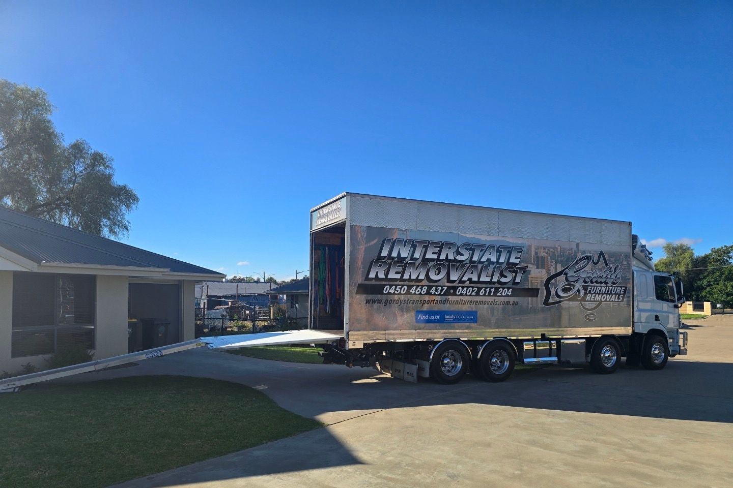 A Moving Truck is Parked in Front of a House — Gordy's Furniture Removals in Lithgow, NSW