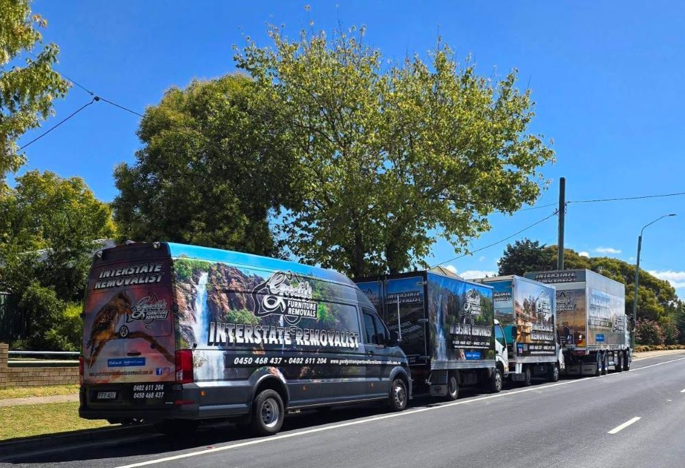 A Row of Different Size Removal Trucks on the Side of the Road — Gordy's Furniture Removals in Lithgow, NSW