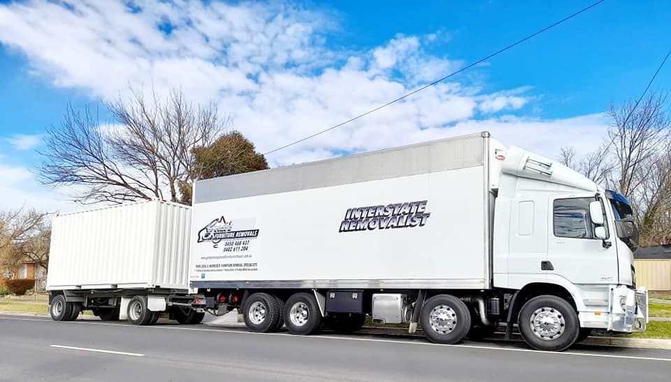 A White Semi Truck Is Parked On The Side Of The Road — Gordy's Furniture Removals in Bathurst, NSW