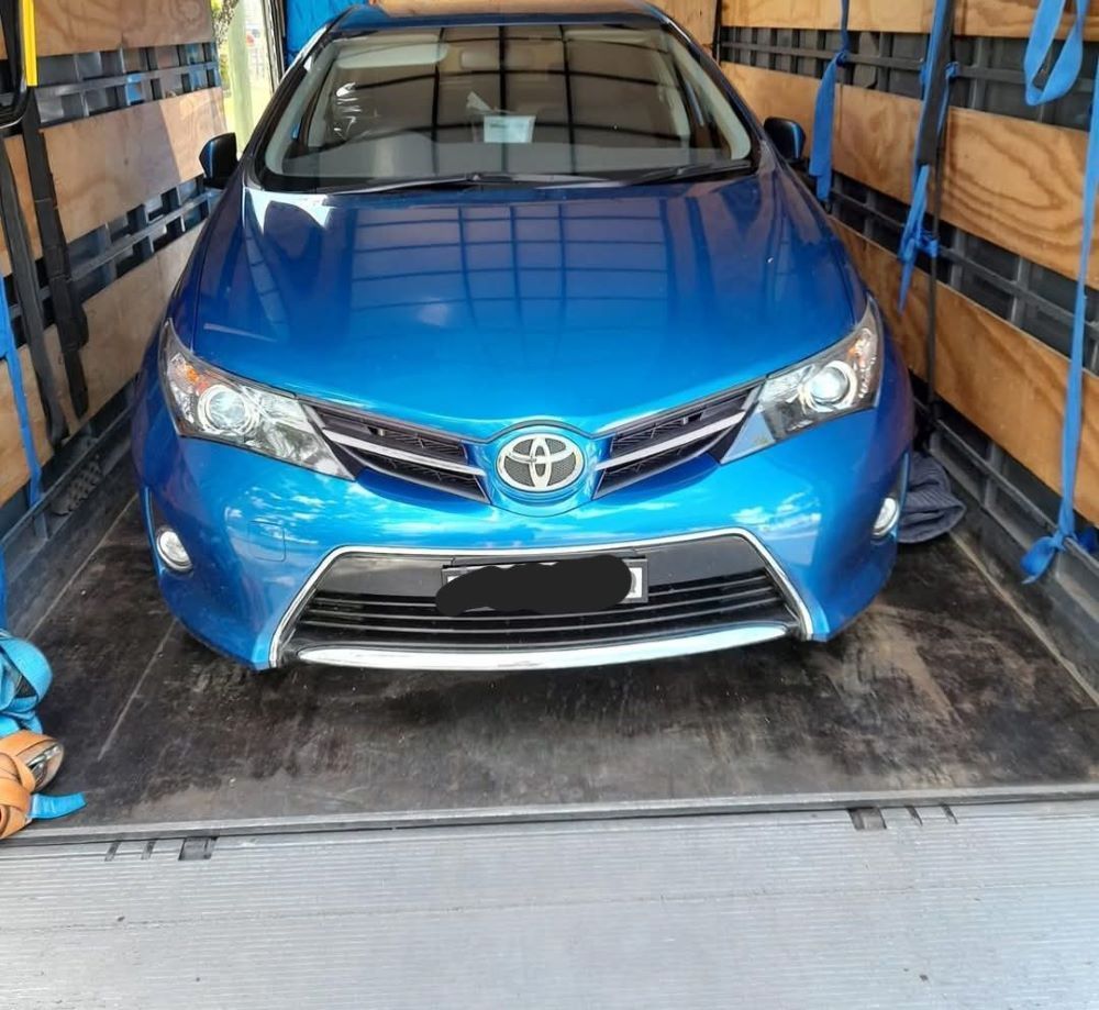A Blue Toyota Car is Sitting in the Back of a Truck — Gordy's Furniture Removals in Bathurst, NSW