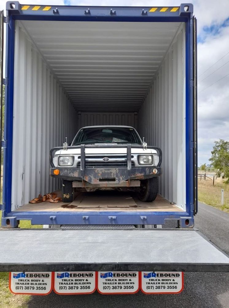 A White Truck is Sitting Inside of a Shipping Container — Gordy's Furniture Removals in Bathurst, NSW
