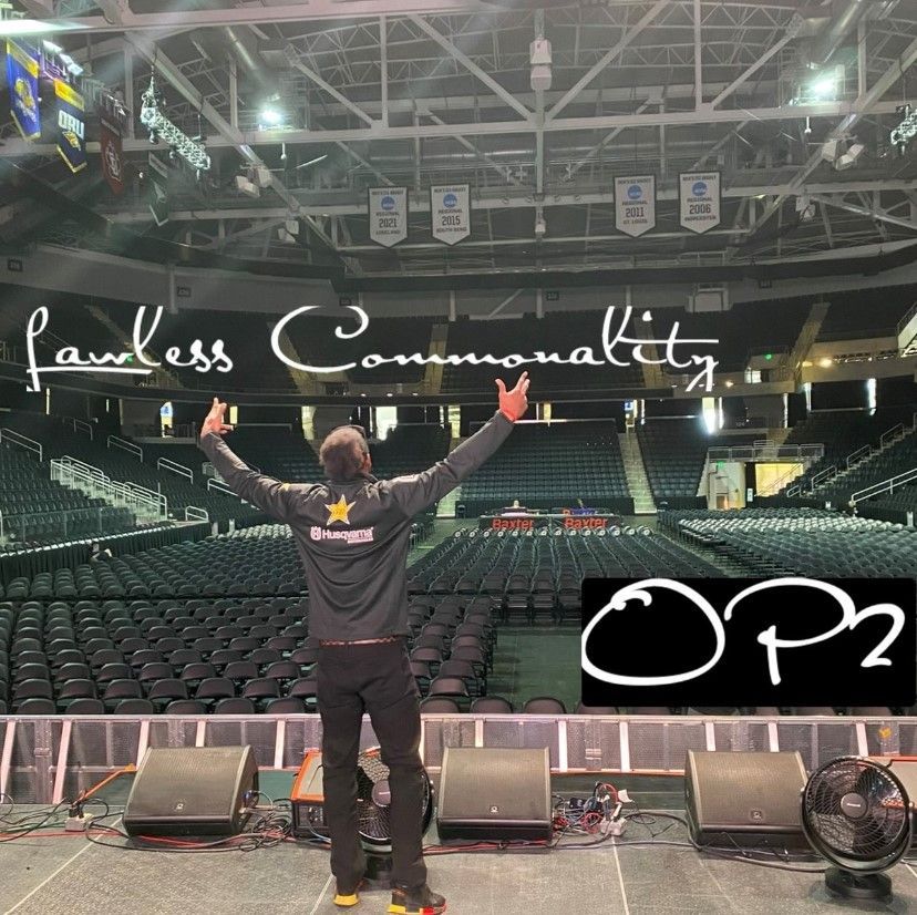 A man stands on a stage in front of a sign that says op2