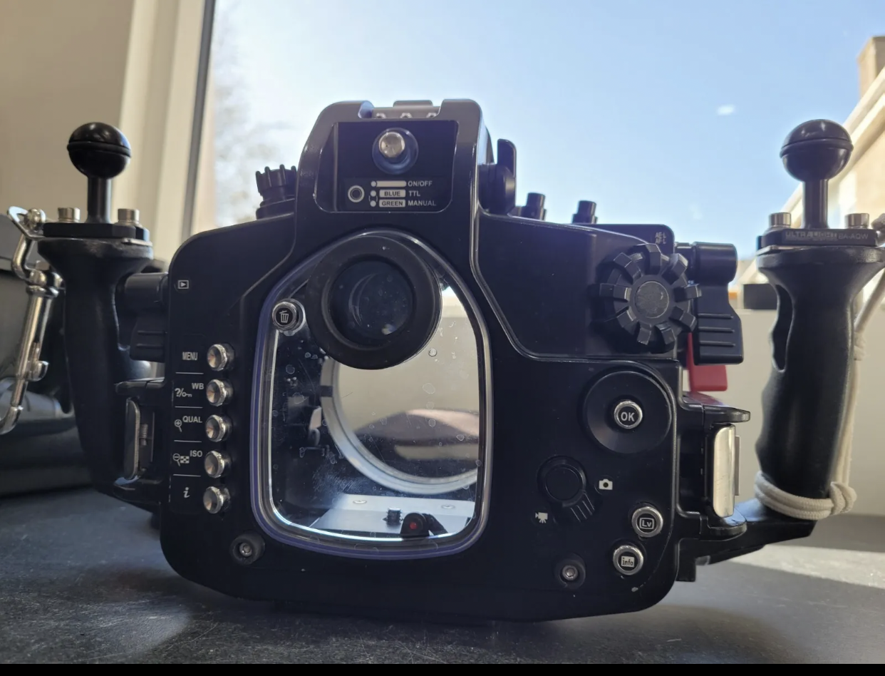 A camera is sitting on a table in front of a window